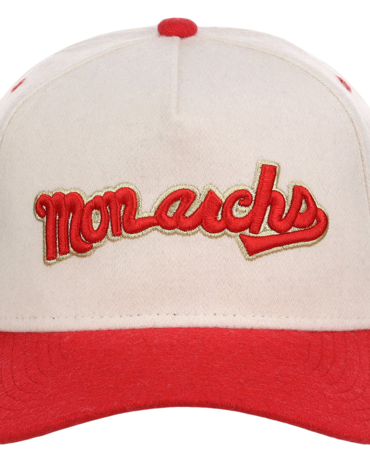 The Ebbets Field Kansas City Monarchs NLB Ballpark A-Frame Ballcap features a cream color with a red brim and stitching. 