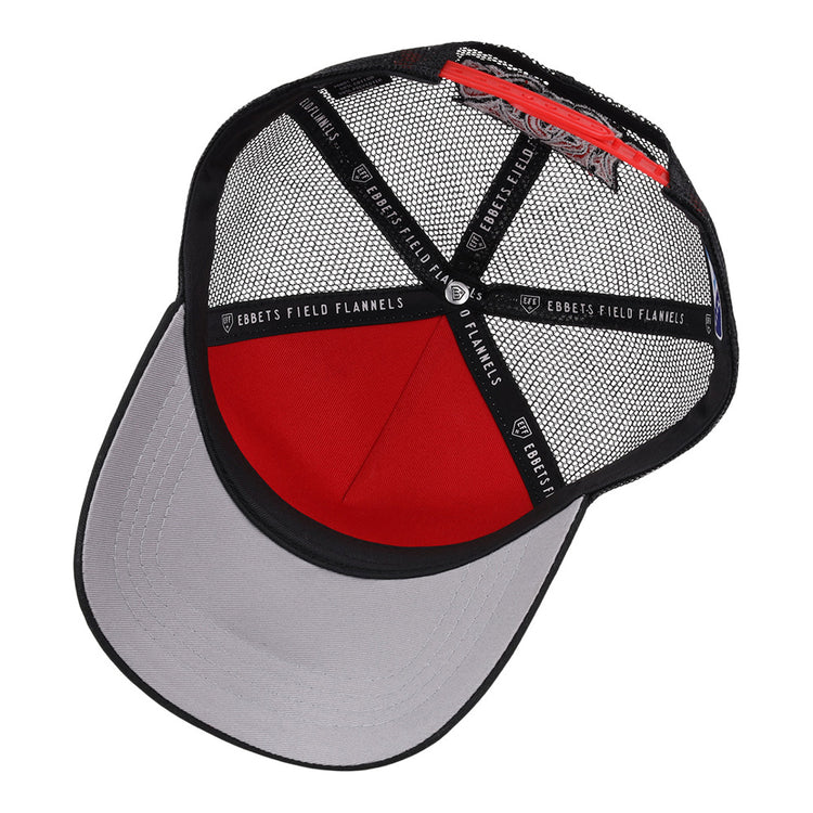 The Lake Elsinore Storm MiLB Trucker Ballcap by Ebbets Field features a red and black mesh crown, gray curved brim, black interior bands with EBBETS FIELD FLANNELS labeling, and an adjustable back strap.