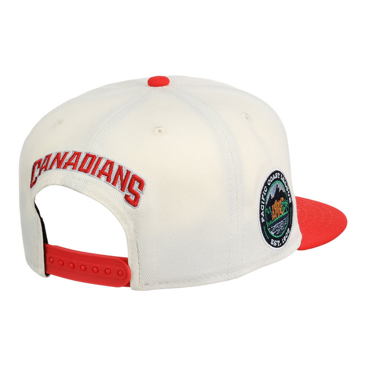 The Ebbets Field Vancouver Canadians MiLB Snapback Ballcap features a white crown, red brim, red adjustable snapback, CANADIANS embroidered in red on the back, and a circular patch on the side.