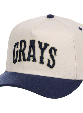 The Ebbets Field Homestead Grays NLB Ballpark A-Frame Ballcap is cream-colored with a navy brim and button, and features 