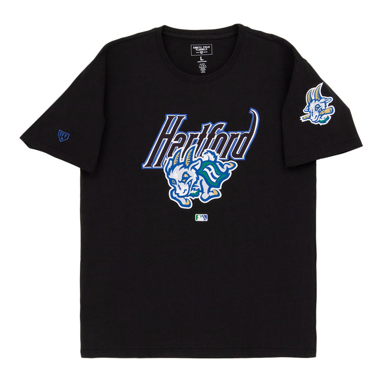 The Ebbets Field Hartford Yard Goats MiLB Fashion Cotton Short Sleeve Tee features a black design with a blue and white Hartford logo, a cartoon blue dinosaur on the chest, and a smaller dinosaur graphic on the left sleeve.