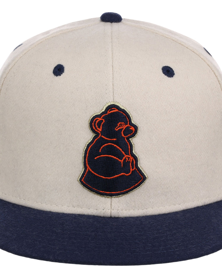 The San Francisco Sea Lions NLB Ballpark Fitted Ballcap by Ebbets Field features a beige crown, navy blue brim and button, and an embroidered dark blue and orange bear outline on the front.
