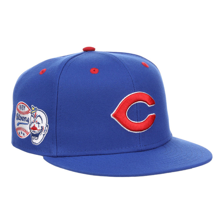 The Ebbets Field Indianapolis Clowns NLB Varsity Fitted Ballcap features a red “C” logo on the front, a clown face with baseball and “Browning” patch on the side, and red ventilation eyelets on the crown.