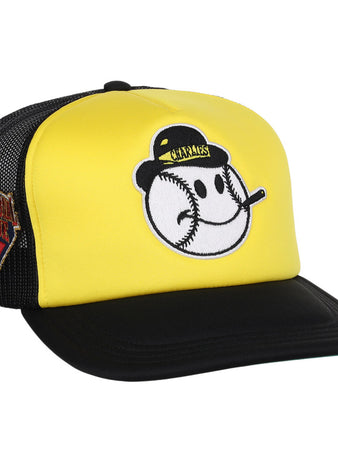 The Charleston Charlies MiLB Vintage Foam Trucker Ballcap by Ebbets Field features a yellow and black design with a smiling baseball face on front and a Venezuelan Professional Baseball League patch on the mesh side panel.