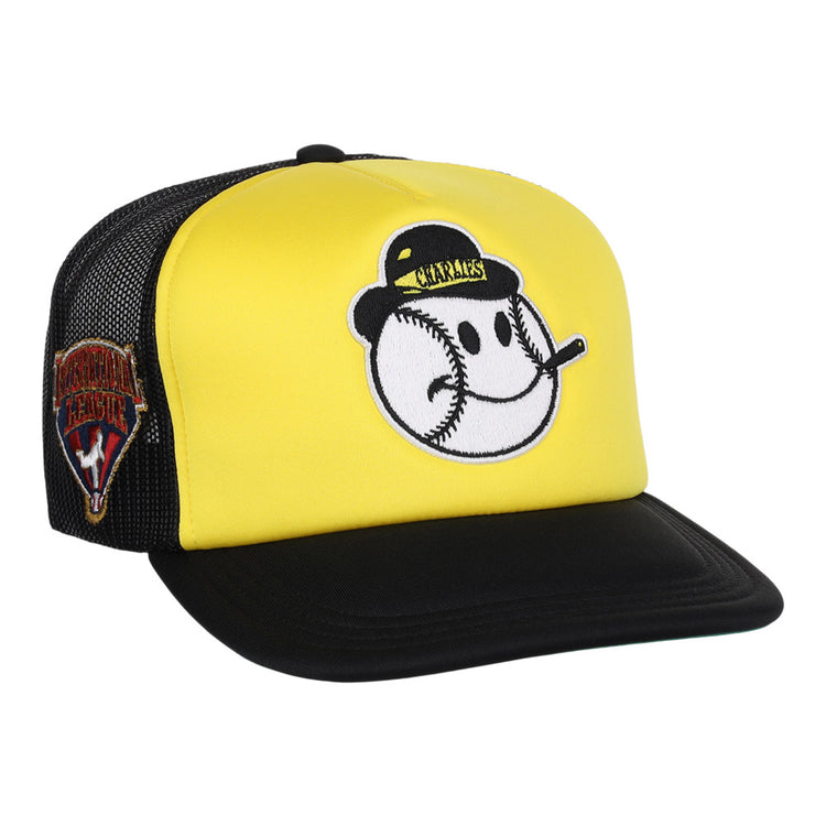 The Charleston Charlies MiLB Vintage Foam Trucker Ballcap by Ebbets Field features a yellow and black design with a smiling baseball face on front and a Venezuelan Professional Baseball League patch on the mesh side panel.