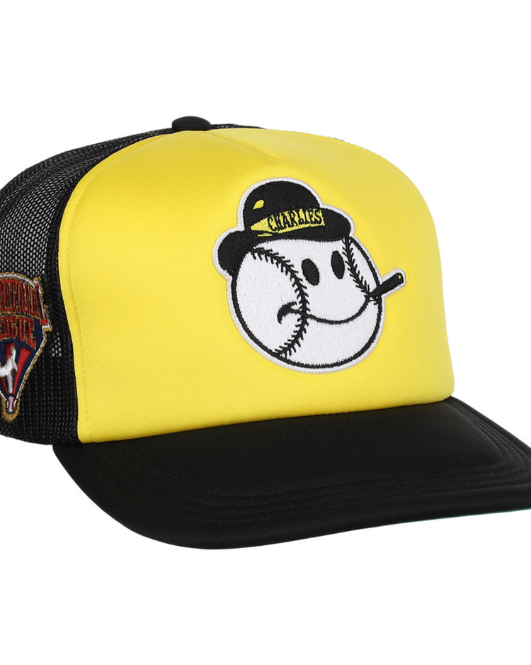 The Charleston Charlies MiLB Vintage Foam Trucker Ballcap by Ebbets Field features a yellow and black design with a smiling baseball face on front and a Venezuelan Professional Baseball League patch on the mesh side panel.