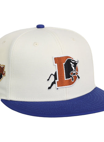 The Ebbets Field Durham Bulls MiLB Two Tone Snapback Ballcap features a white crown, blue brim, bold orange and black 