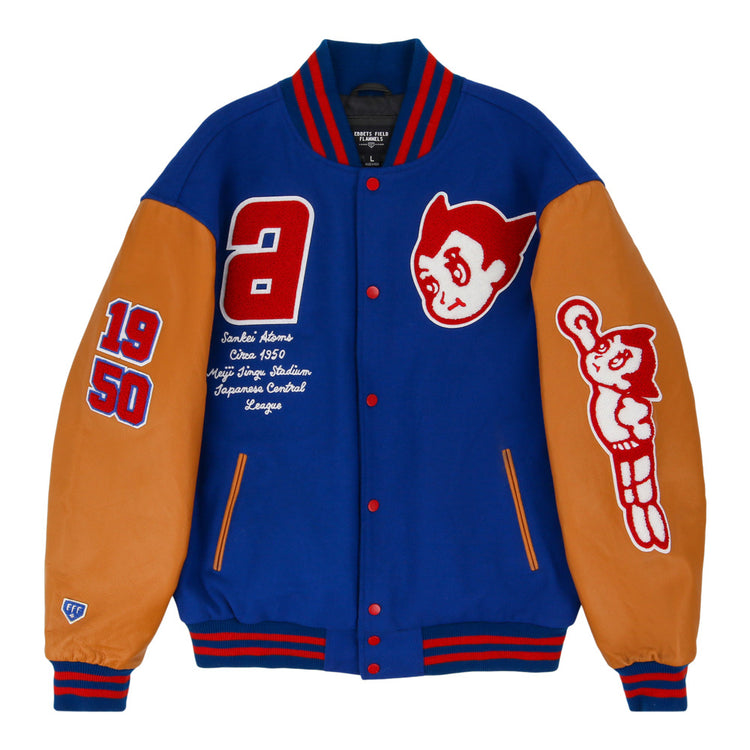 The Sankei Atoms Dna Varsity Jacket by Ebbets Field is a blue varsity jacket with tan leather sleeves, red and white patches featuring 