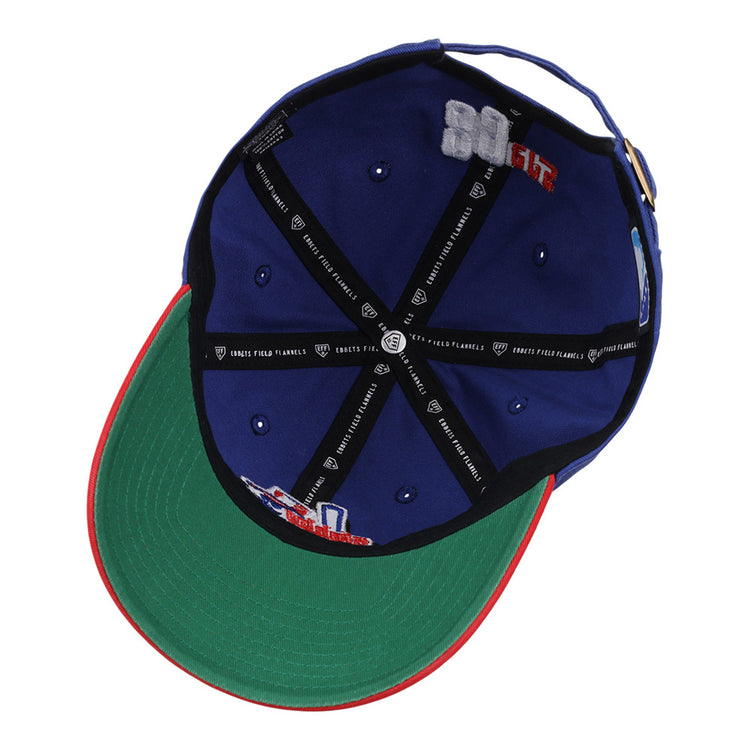 The Ebbets Field Oklahoma City 89Ers MiLB Logo Dad Ballcap is blue, with a green underbrim, red edge, black inner seams with white text, and embroidered interior patches.
