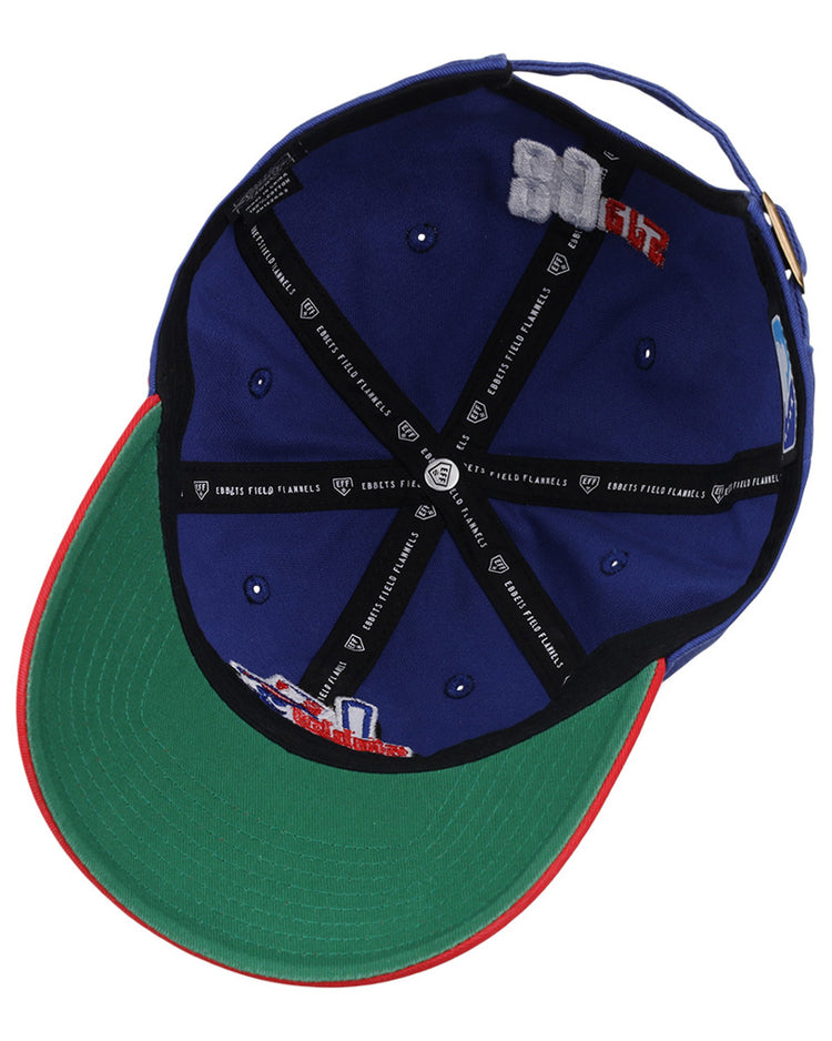 The Ebbets Field Oklahoma City 89Ers MiLB Logo Dad Ballcap is blue, with a green underbrim, red edge, black inner seams with white text, and embroidered interior patches.