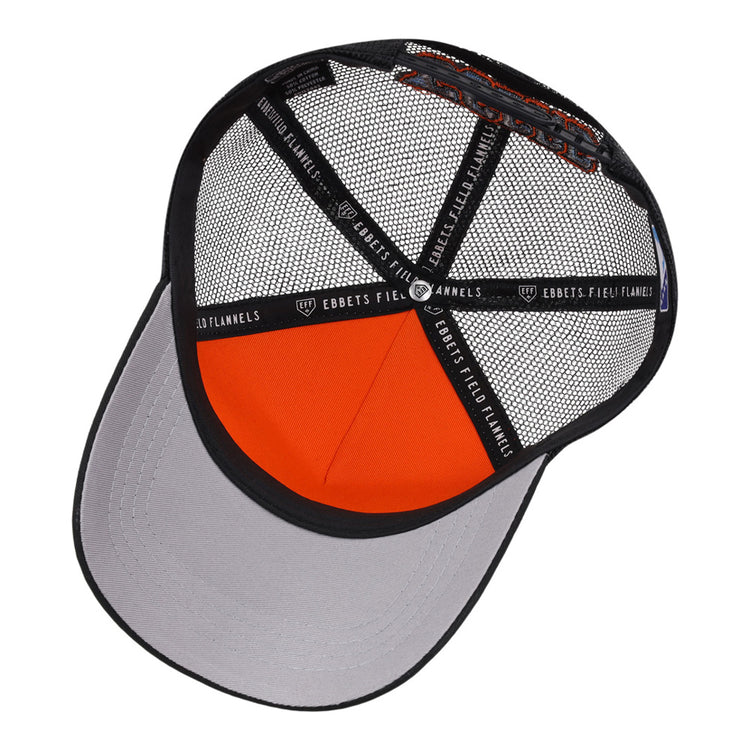 The underside of the Inland Empire 66Ers MiLB Trucker Ballcap by Ebbets Field is shown, displaying the mesh panels, interior structure, gray bill, and black fabric strips labeled EBBETS FIELD FLANNELS.