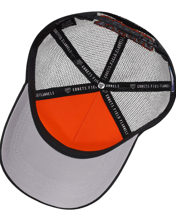 The underside of the Inland Empire 66Ers MiLB Trucker Ballcap by Ebbets Field is shown, displaying the mesh panels, interior structure, gray bill, and black fabric strips labeled EBBETS FIELD FLANNELS.