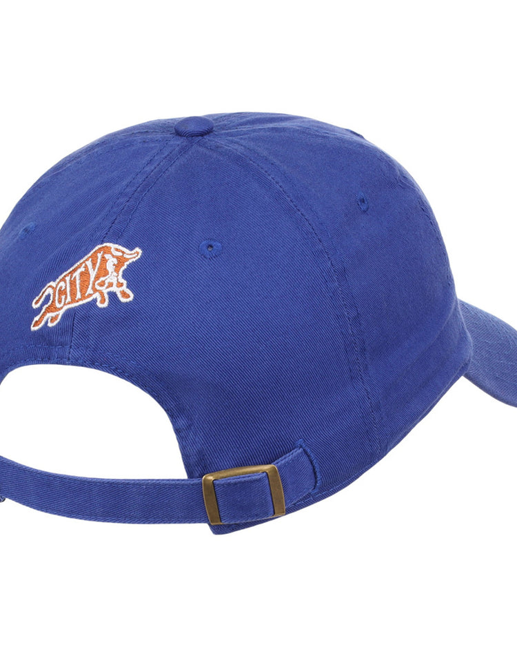 The Ebbets Field Durham Bulls MiLB Dad Ballcap is blue, viewed from the back with an adjustable strap and metal buckle, and has an embroidered orange and white bull logo plus 