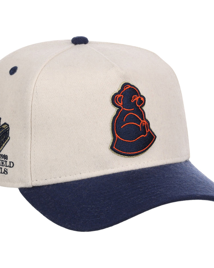 The San Francisco Sea Lions NLB Ballpark A-Frame Ballcap by Ebbets Field features a beige crown, navy brim, dark blue top button, an outlined bear logo on the front, and stadium embroidery with text on the side.