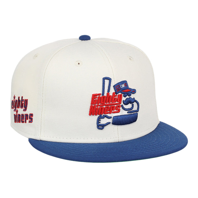 The Ebbets Field Oklahoma City 89Ers MiLB Logo Wordmark Snapback Ballcap features a white crown, blue brim, an embroidered cartoon mascot with 