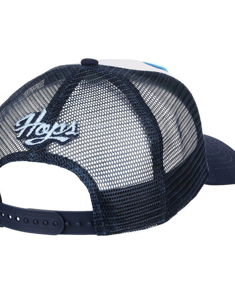 The Hillsboro Hops MiLB Trucker Ballcap by Ebbets Field is a navy blue mesh snapback, shown from the back with “Hops” embroidered in white above the adjustable strap.