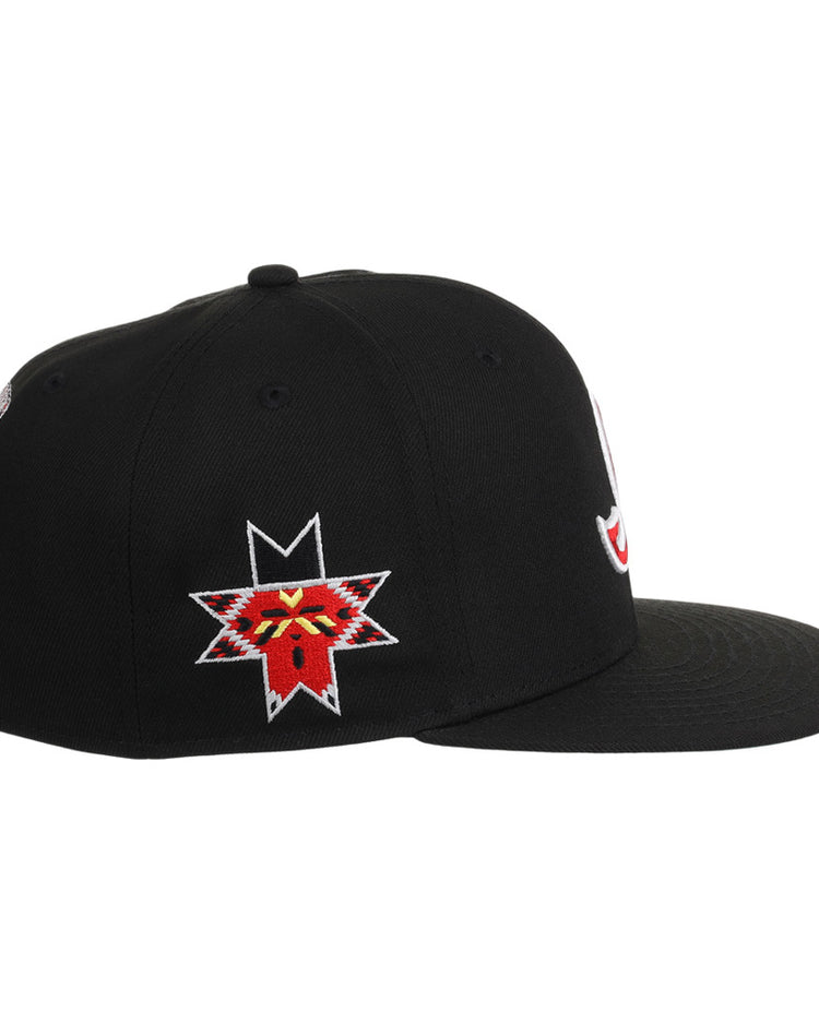 The Ebbets Field Indianapolis Indians MiLB Snapback Ballcap is a black flat-brim cap with a vibrant embroidered red and yellow animal face inside a star on the left side.
