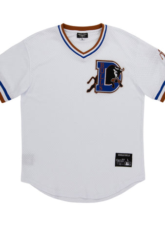 The Ebbets Field Durham Bulls MiLB V-Neck Jersey is a white jersey with blue and brown trim, showcasing a large D Bulls logo with a bull on the left chest and a label patch near the bottom hem.