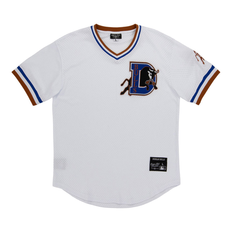 The Ebbets Field Durham Bulls MiLB V-Neck Jersey is a white jersey with blue and brown trim, showcasing a large D Bulls logo with a bull on the left chest and a label patch near the bottom hem.