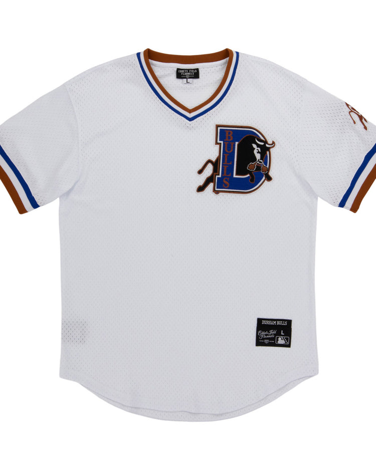 The Ebbets Field Durham Bulls MiLB V-Neck Jersey is a white jersey with blue and brown trim, showcasing a large D Bulls logo with a bull on the left chest and a label patch near the bottom hem.