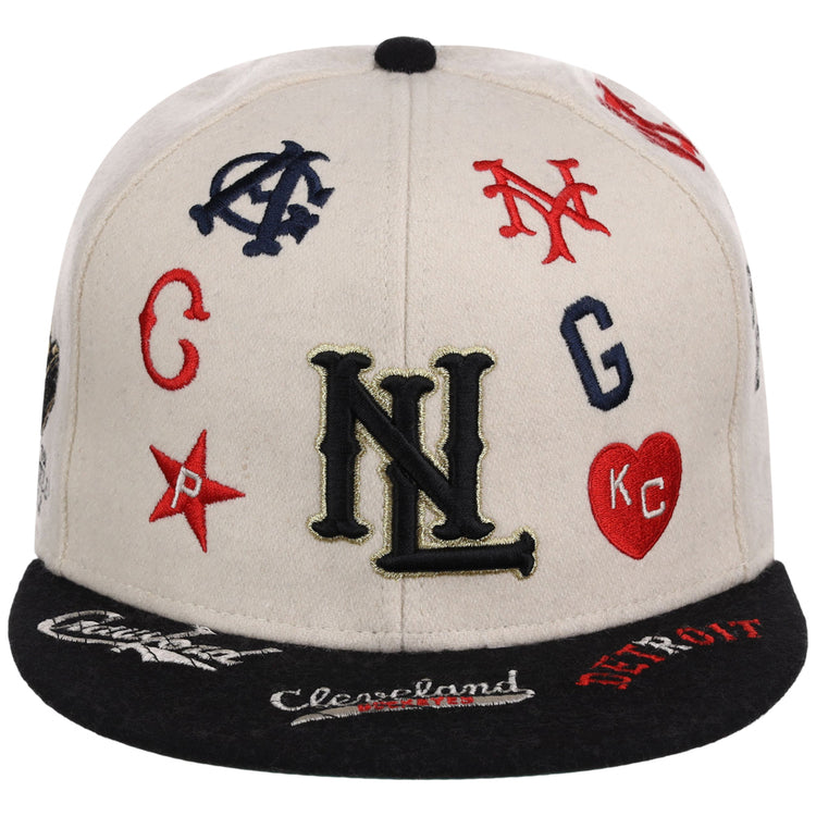 The Ebbets Field Negro League Baseball NLB Ballpark Fitted Ballcap is a beige and black cap featuring embroidered NL on the front and colorful Negro League team logos and icons scattered around.