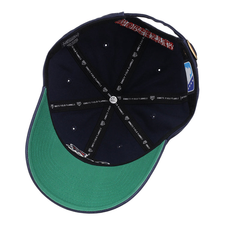 The underside of the Worcester Red Sox MiLB Dad Ballcap by Ebbets Field features a green brim, multiple logos, stitched black taping with white text, a gold buckle strap, and a blue patch on the inner back.