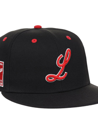 The Louisville Black Caps NLB Varsity Fitted Ballcap by Ebbets Field is a black cap featuring a red and white embroidered “L,” red button and eyelets, plus a red side patch reading “L League Caps, Louisville Baseball Club.”.