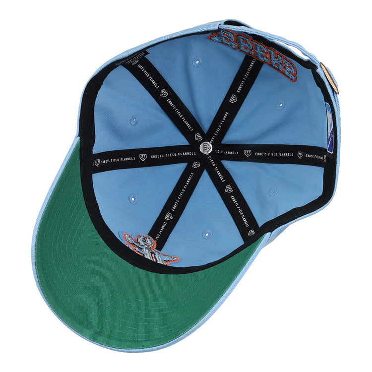 The inside view of the Ebbets Field Inland Empire 66Ers MiLB Dad Ballcap features a light blue exterior, green underside brim, black interior taping with white text, and embroidered patches on the inner crown.