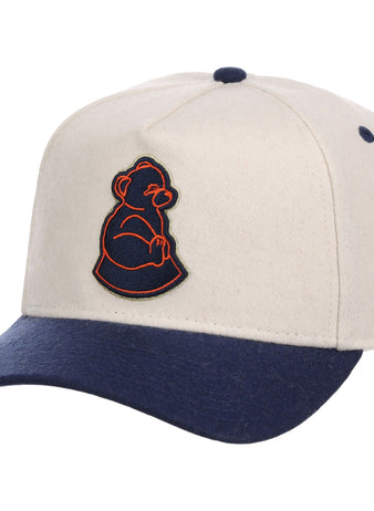 The Ebbets Field San Francisco Sea Lions NLB Ballpark A-Frame Ballcap features a beige crown, navy blue brim and button, plus an embroidered orange and navy outline of a seated bear on the front.