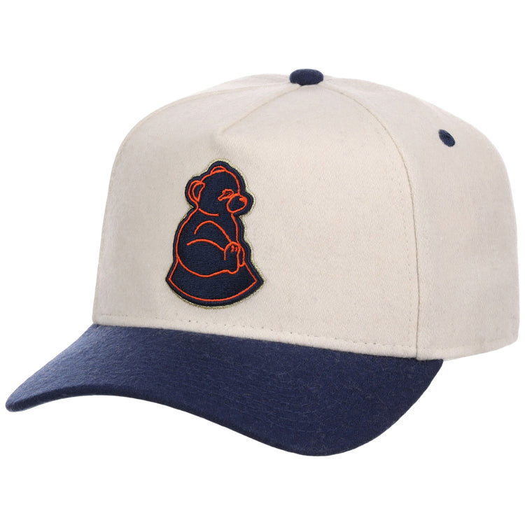 The Ebbets Field San Francisco Sea Lions NLB Ballpark A-Frame Ballcap features a beige crown, navy blue brim and button, plus an embroidered orange and navy outline of a seated bear on the front.