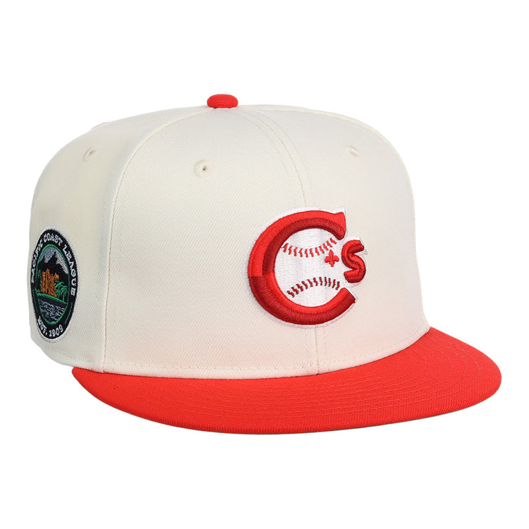 The Vancouver Canadians MiLB Snapback Ballcap by Ebbets Field is a cream cap with a red brim, featuring a red and white C logo with baseball stitching on the front and a circular patch with trees and text on the side.