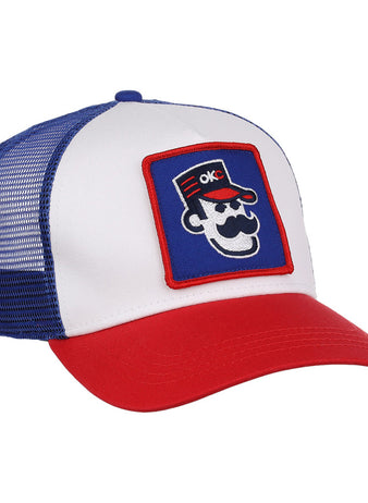 The Ebbets Field Oklahoma City 89Ers MiLB Trucker Ballcap features a white front panel, blue mesh back, red brim, and a patch of a cartoon face with sunglasses, mustache, red hat, and OKC letters.