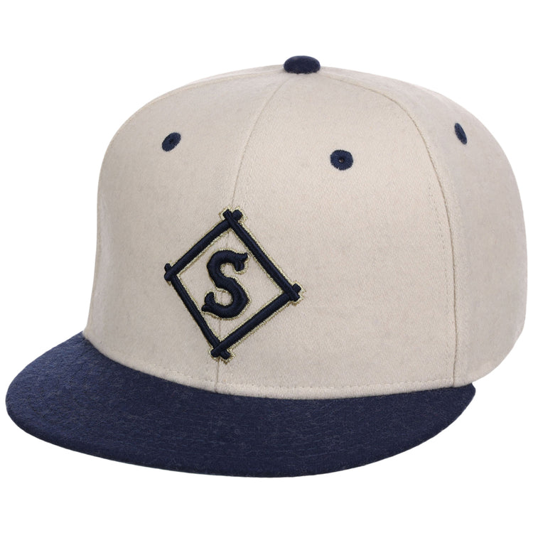 The Ebbets Field Seattle Steelheads NLB Ballpark Fitted Ballcap is beige with a navy brim and button, and displays a navy 