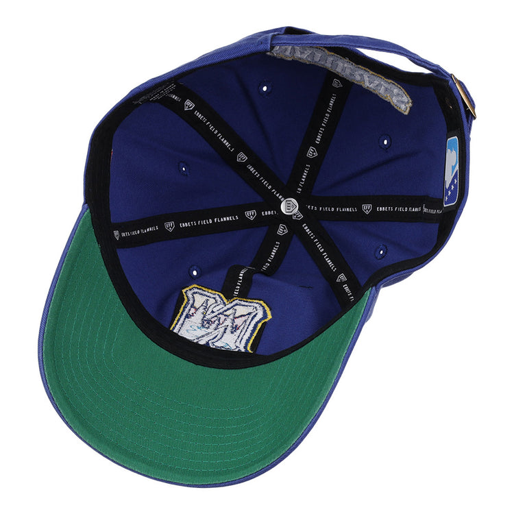 An inside view of the Northwest Arkansas Naturals MiLB Dad Ballcap by Ebbets Field, featuring a blue crown, green brim, black inner bands with the Ebbets Field label, and a stitched M logo on the underside.