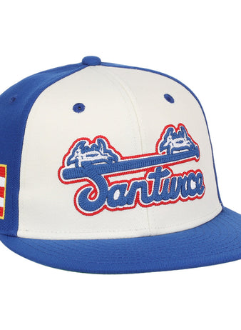 The Ebbets Field Santurce Cangrejeros Wordmark Chainstitch Fitted Ballcap features blue panels and brim, a white front with blue and red 