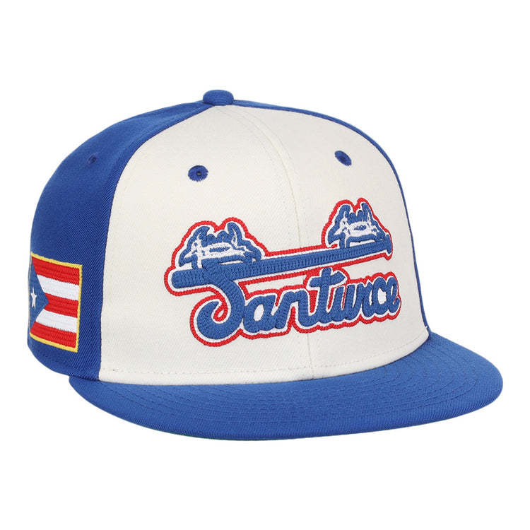 The Ebbets Field Santurce Cangrejeros Wordmark Chainstitch Fitted Ballcap features blue panels and brim, a white front with blue and red 