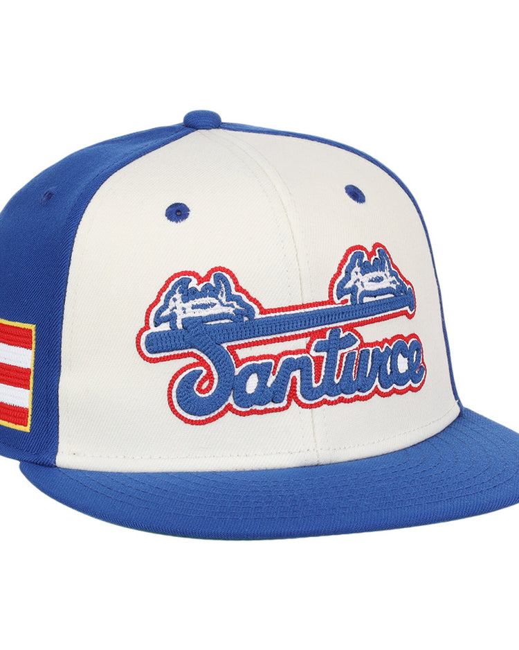 The Ebbets Field Santurce Cangrejeros Wordmark Chainstitch Fitted Ballcap features blue panels and brim, a white front with blue and red 