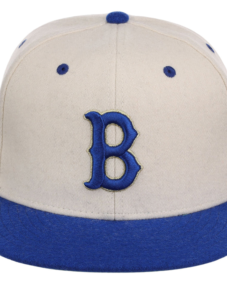 The Ebbets Field Brooklyn Royal Giants NLB Ballpark Fitted Ballcap is cream with a blue brim and accents, showcasing a large blue 