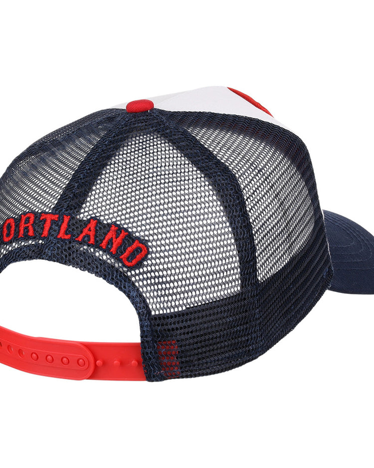 The Ebbets Field Portland Sea Dogs MiLB Trucker Ballcap is a navy blue mesh hat with a red adjustable snapback and PORTLAND embroidered in red above the back opening.