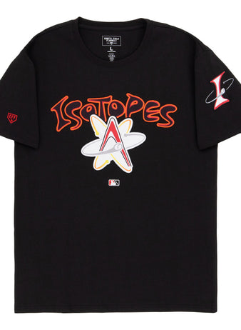 The Ebbets Field Albuquerque Isotopes MiLB Fashion Cotton Short Sleeve Tee is a black shirt with bold Isotopes text and an atomic logo, a red “L” atom logo on the left sleeve, and an MLB logo near the bottom center.