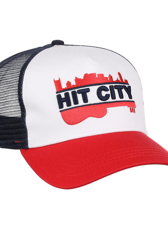 The Ebbets Field Nashville Sounds MiLB Logo Wordmark Trucker Ballcap features a white front, red brim, black mesh back, and a bold red guitar with city skyline and 