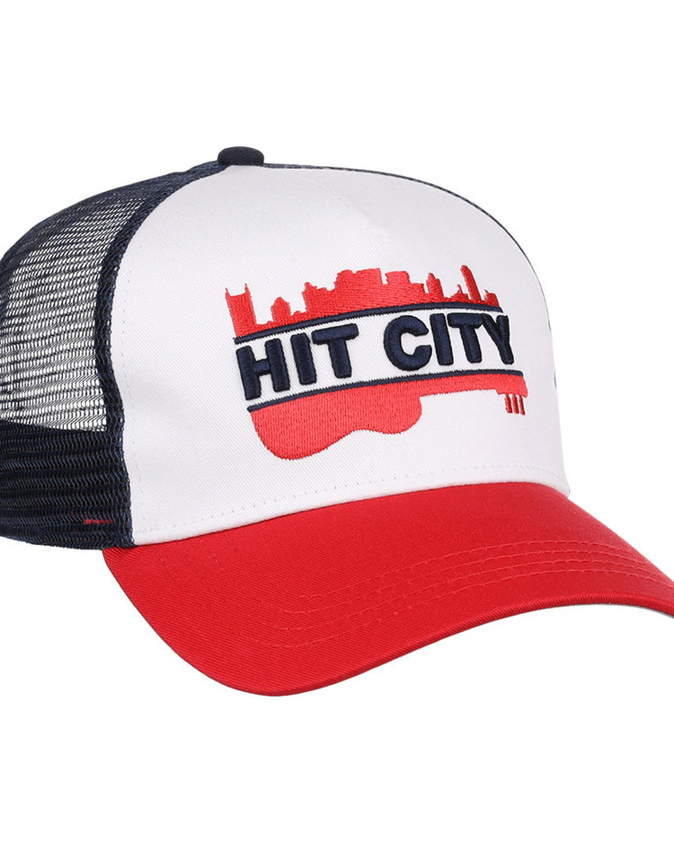 The Ebbets Field Nashville Sounds MiLB Logo Wordmark Trucker Ballcap features a white front, red brim, black mesh back, and a bold red guitar with city skyline and 