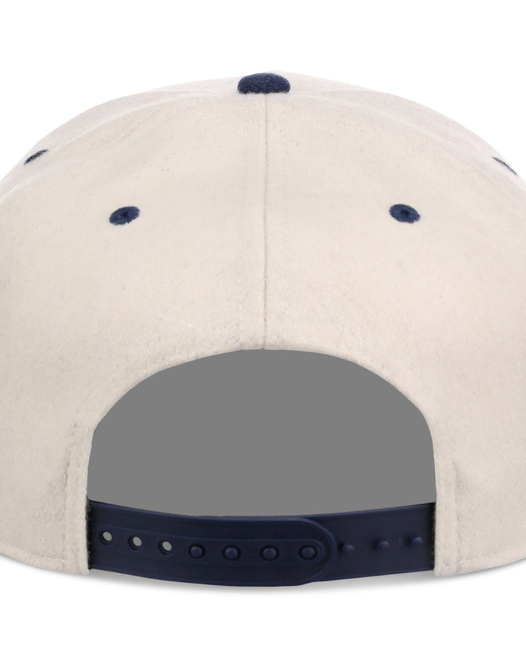 The Ebbets Field Homestead Grays NLB Ballpark A-Frame Ballcap is beige, shown from the back with a dark blue adjustable snapback strap and blue ventilation eyelets.