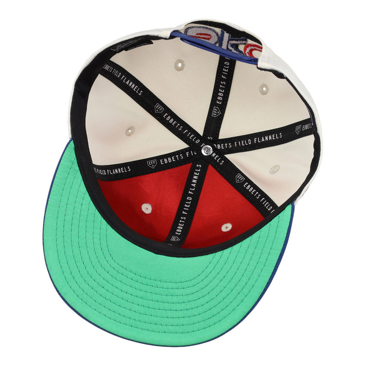 The underside of the Oklahoma City 89Ers MiLB Logo Wordmark Snapback Ballcap by Ebbets Field features a green brim, beige and red panels, black ribbons with EBBETS FIELD FLANNELS text, and metal rivets at the panel intersections.