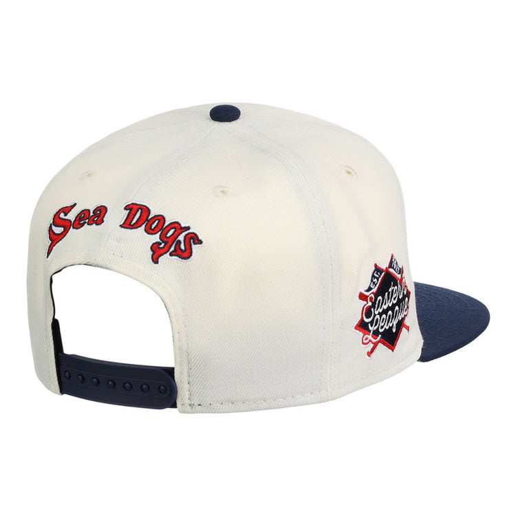 The Ebbets Field Portland Sea Dogs MiLB Snapback Ballcap features a white crown, navy blue brim, adjustable strap, 