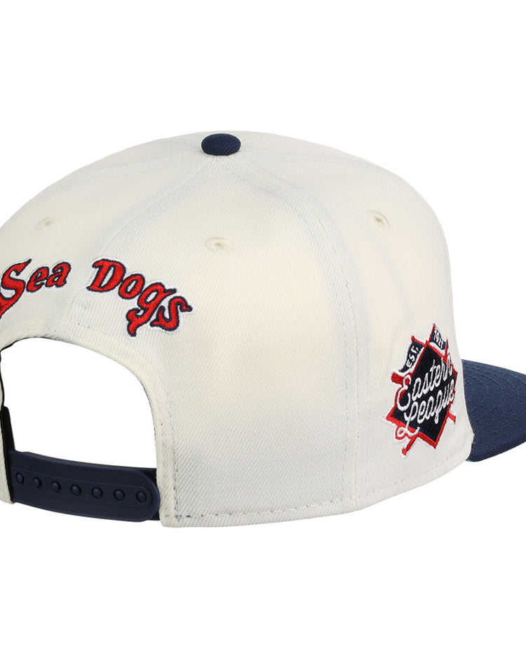 The Ebbets Field Portland Sea Dogs MiLB Snapback Ballcap features a white crown, navy blue brim, adjustable strap, 