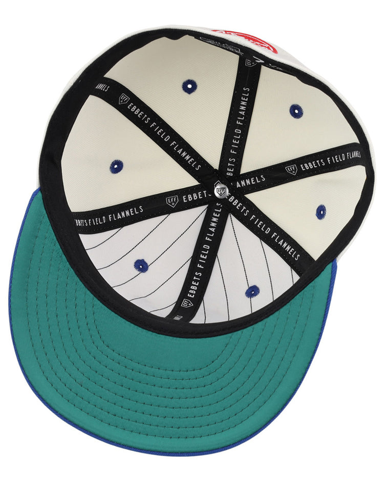 Inside view of the Ebbets Field Santurce Cangrejeros Chainstitch Fitted Ballcap reveals a green underbrim, white crown with vertical black pinstripes, blue rivets, and black taping labeled 