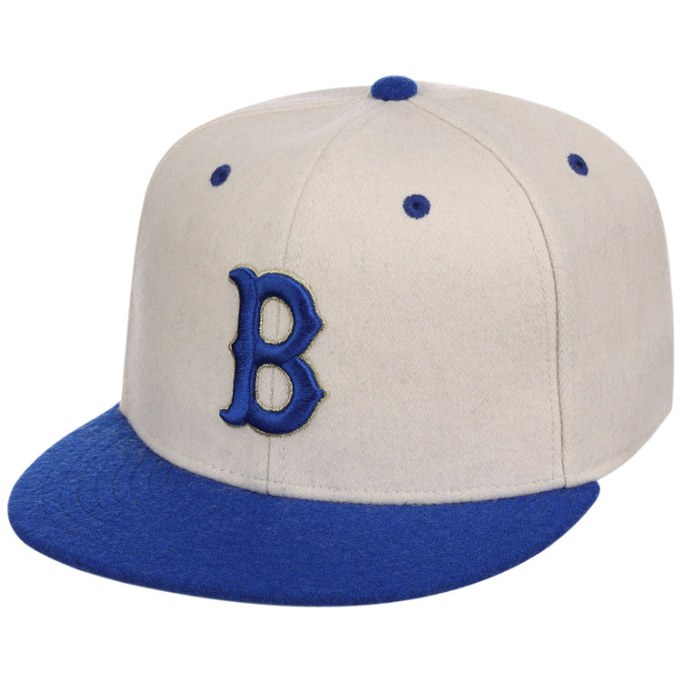 The Ebbets Field Brooklyn Royal Giants NLB Ballpark Fitted Ballcap features a beige crown with blue brim, top button, embroidered B on the front, and blue eyelets.