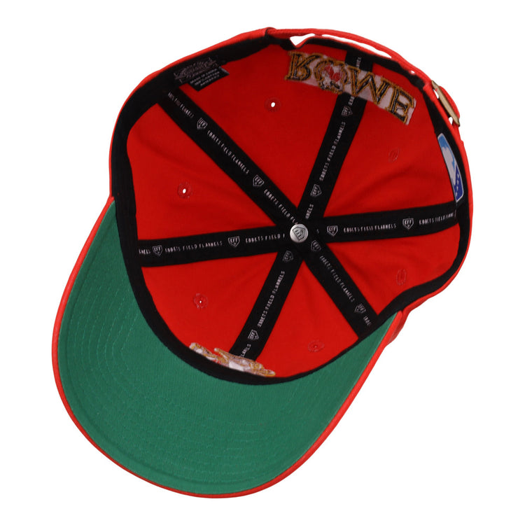 The Rome Emperors MiLB Dad Ballcap by Ebbets Field is red and flipped upside down, showing a green underbrim, black inner lining with white text, and embroidered crown patches including the word LOVE.