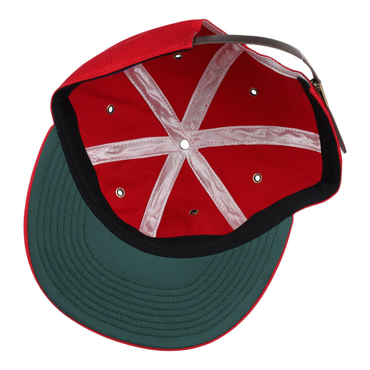 The image shows the inside of an Ebbets Field Seattle Rainiers MiLB Cotton Ballcap with a red crown, green underbill, black trim, white seams, and an adjustable strap at the back.